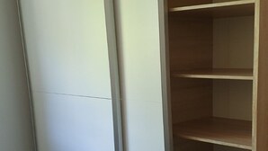 A part of a room with a white wall and a wooden shelf unit. - Family-friendly Apartment Crikvenica (Crikvenica)