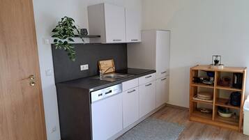 Fridge, stovetop, dishwasher, coffee/tea maker