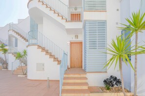 Stunning multi-level building with a central staircase and charming exterior details.