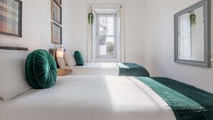 A bedroom with two beds, a window, and a door. - Thistle Do Nessly, Inverness (Inverness)