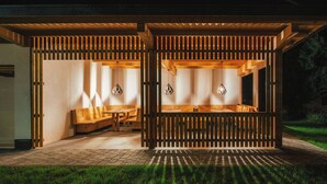 A wooden structure with benches and hanging lights, likely a relaxation area. - Ferienresidenz Raich (Ried im Oberinntal)