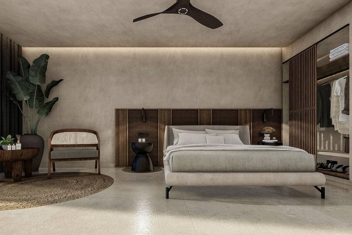 A modern bedroom with a bed, a chair, a side table, a potted plant, and a wardrobe.