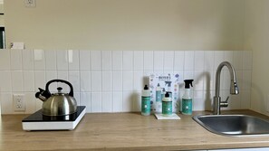 Microwave, stovetop, coffee/tea maker, cookware/dishes/utensils