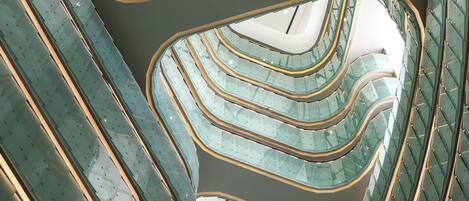 A multi-level atrium with glass railings and a central open space.