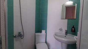 Shower, hair dryer, towels, toilet paper