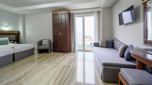 A modern living room with a sofa, a chair, a TV, and a wardrobe. - EONA BEACH RESORT by Greek Pride (Thermaikos)