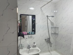 A bathroom with a white sink, mirror, and shower. - Chaqar 50 (Tashkent)