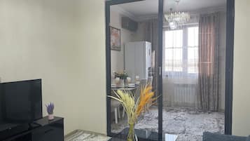 Family Condo, Balcony, City View | Living area | Flat-screen TV