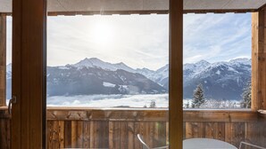 A wooden deck with a view of snow-covered mountains. - Pleasant Apartment With Shared Sauna (Mittersill)