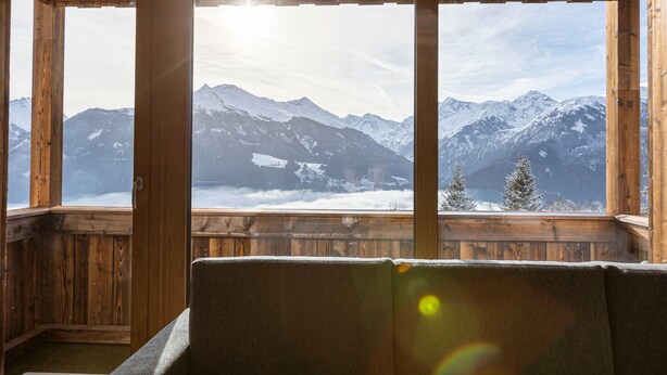 A wooden cabin with large windows offering a view of snow-covered mountains. - Pleasant Apartment With Shared Sauna (Mittersill)