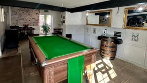 A billiards table in a room with a stone floor, a wooden cabinet, and a mirror on the wall. - Wellington Studio, Sleeps 2, Pets Ok, Free Parking (Northallerton)