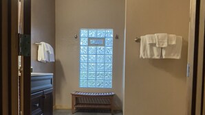 A hallway with a bench, a window with a geometric pattern, and a door with a towel hanging on it. - Shasta Cottage, A romantic get-away in Mt. Shasta. (Mt. Shasta)
