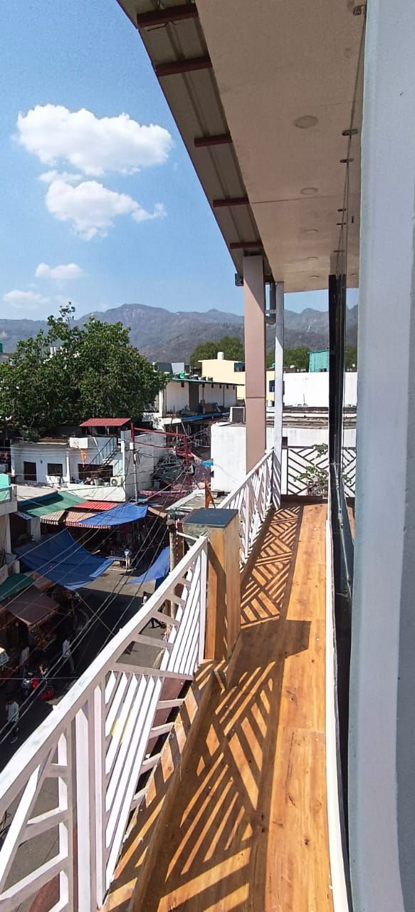 Ein Balkon mit Blick auf eine Stadtlandschaft und Berge.