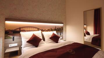 A hotel room with a bed, a mirror, and a view of a bridge.