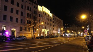 A nighttime street scene with buildings, parked cars, and streetlights. - Hotel Golden Pearl Magdeburg Im Stadtzentrum (Magdeburg)