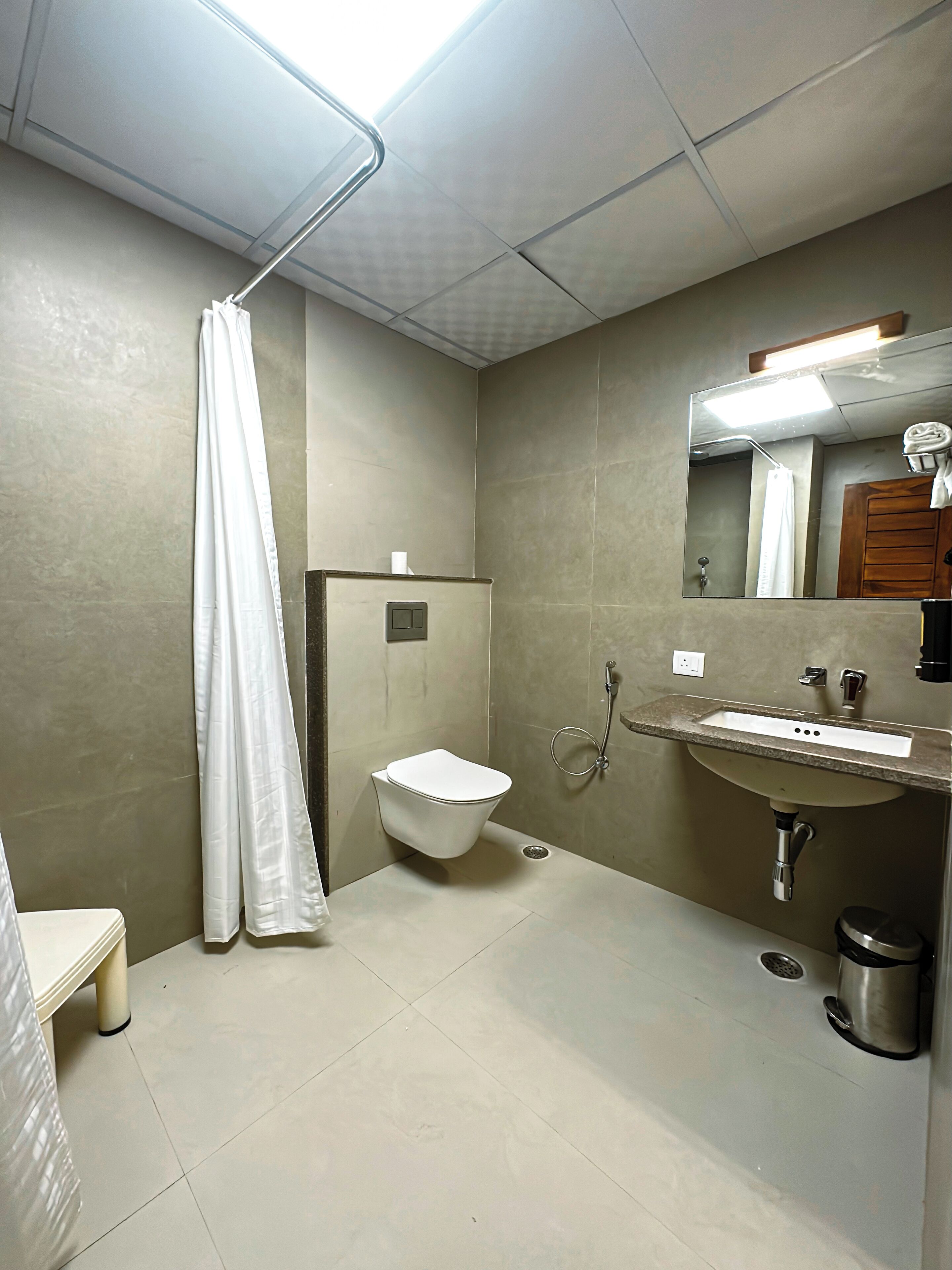 A modern bathroom with a toilet, sink, and shower.