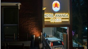A hotel entrance with a sign reading "Hotel Ananda Kashi" and a parked car. - Hotel Ananda Kashi (Varanasi)