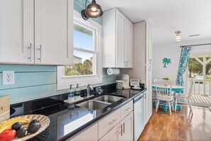 Fridge, microwave, oven, dishwasher - Enjoy a cozy stay at The Marlin House, a 3-bedroom retreat in scenic Holden Beach. (Holden Beach)