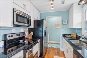 Fridge, microwave, oven, dishwasher - Enjoy a cozy stay at The Marlin House, a 3-bedroom retreat in scenic Holden Beach. (Holden Beach)