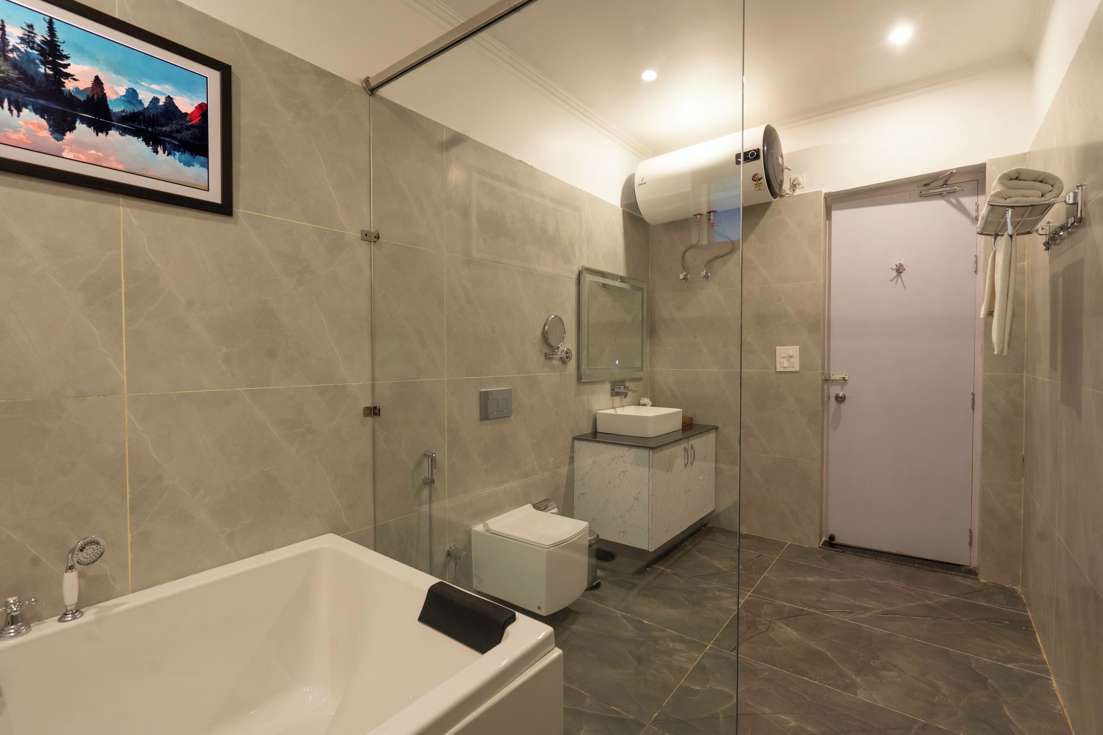 A modern bathroom with a bathtub, a shower, and a toilet.