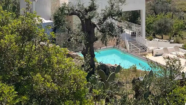 A modern building with a pool, surrounded by greenery and hills. - Beautiful villa with scenic views, located between Ostuni & Cisternino. (Ostuni)