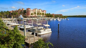 A marina with boats docked, a waterfront building, and a clear sky. - Brand New!! Spacious Elegant Home with Heated Pool, BBQ and Amazing Lake Views (Naples)
