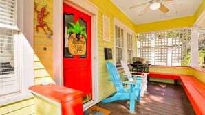 A porch with a red door, a ceiling fan, and a wooden deck. - Spacious Home with Bikes, Near Historic Downtown (St. Augustine)