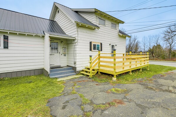A two-story building with a front door, a small porch, and a wooden fence. - Near Skiing & Snowmobiling: Home in Mars Hill! (Mars Hill)