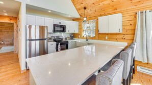 A modern kitchen with white cabinets, stainless steel appliances, and a large island. - Cabin 4 Mi to Belleayre Mountain: Ski, Hike & Fish (Fleischmanns)