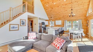 A spacious living room with a grey sectional sofa, wooden ceiling, and a staircase leading to an upper level. - Cabin 4 Mi to Belleayre Mountain: Ski, Hike & Fish (Fleischmanns)
