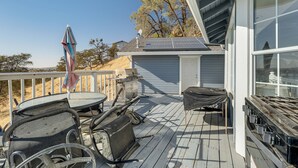 A deck with outdoor furniture, a grill, and solar panels. - Water Views & Decks: Spacious La Grange Retreat (La Grange)