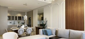 A modern living room with a sofa, dining table, and chairs. There is a kitchen visible through an open door.