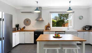 Enjoy cooking in this kitchen with a central island, dishwasher, and stainless steel refrigerator.