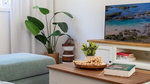 Relax in this serene living area with a comfortable sofa, coffee table, and bookshelf.