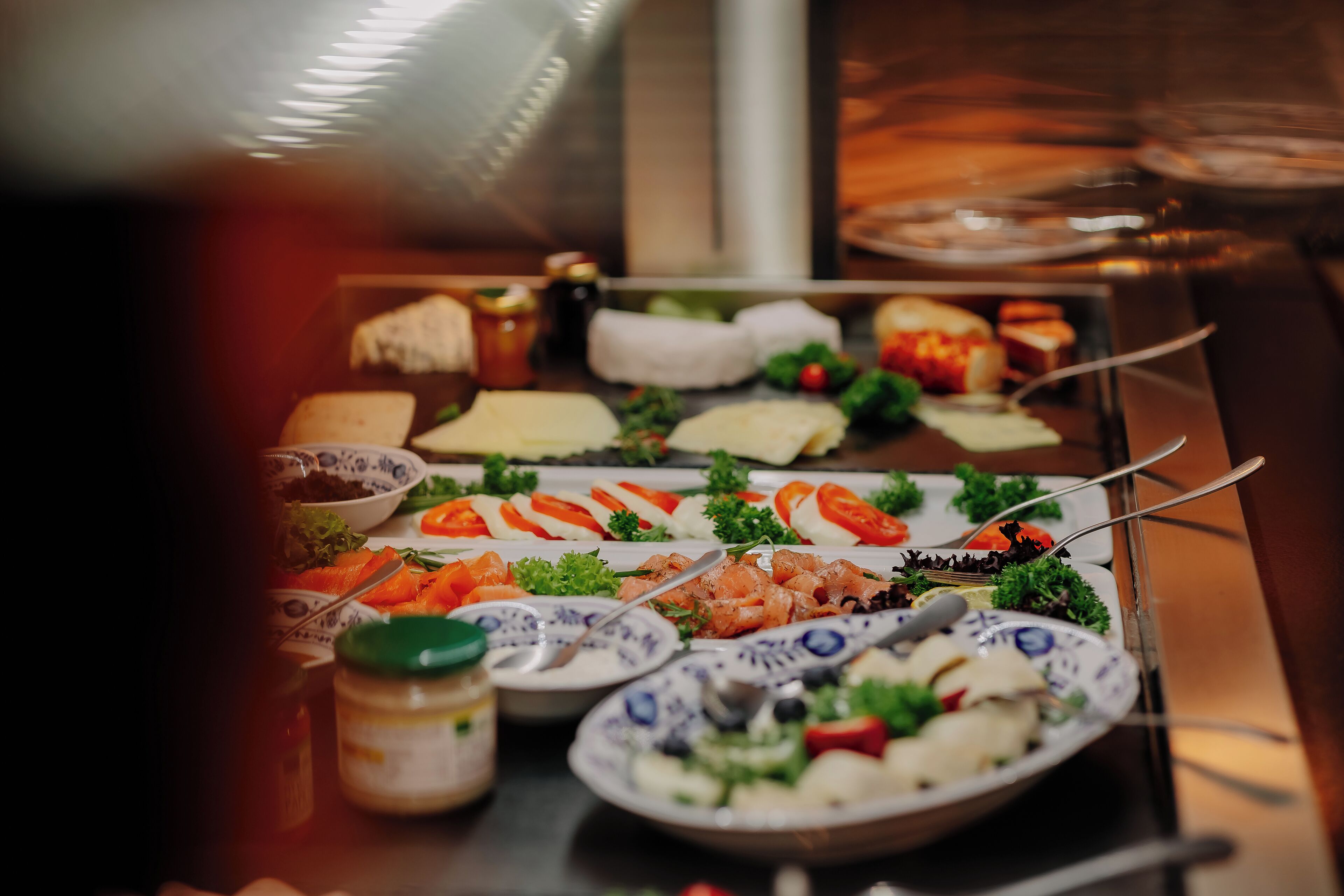 A buffet table with various dishes including seafood, salads, and bread.