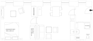 Plan d’un étage d’une chambre d’hôtel comprenant un lit « king size », un canapé-lit, une armoire, une douche, des toilettes et un lave-linge.