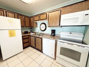 Enjoy cooking in this fully equipped kitchen with a refrigerator, dishwasher, microwave, and stove.