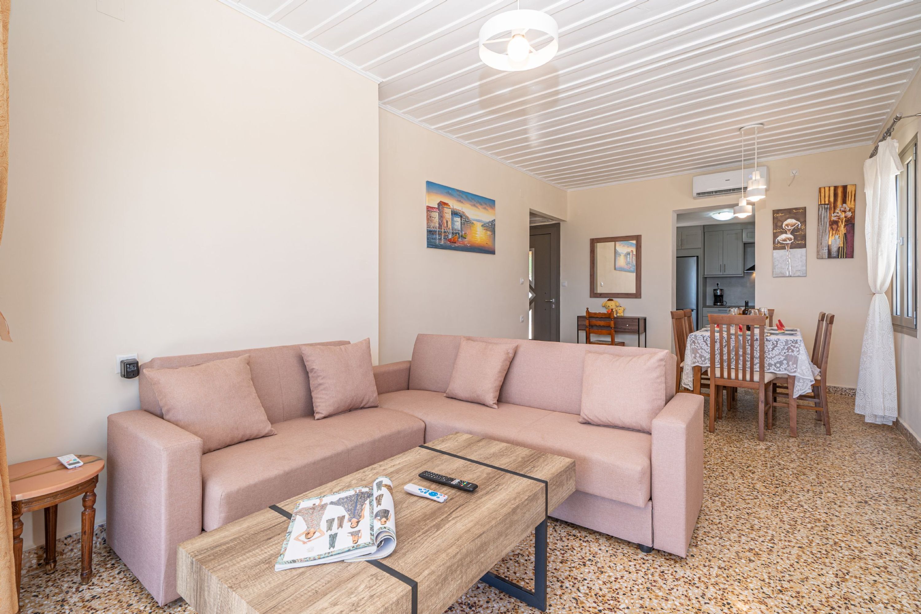 Un salon comprenant un canapé, une table basse et un coin repas avec des chaises et une table.