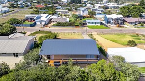 A residential area with houses, a road, and a view of the ocean. - The Beach House 64 Neighbour Ave Goolwa Beach (Goolwa)