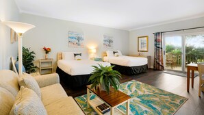 A hotel room with two beds, a sofa, a coffee table, a plant, and a view of the outdoors. - Garden Studio | Sleeps 4 | Near Historic St. Augustine (St. Augustine)