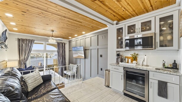 A modern kitchen with white cabinets and a built-in oven. - Harbor View Studio | King Bed + Covered Balcony | Dogs OK (St. Augustine)