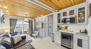 A modern kitchen with white cabinets and a built-in oven.