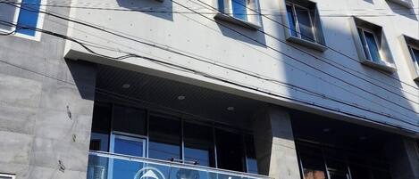 A multi-story building with a modern architectural design, featuring a prominent sign with the name "BEP" and the word "HANOI" indicating its location.