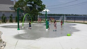 A water play area with multiple water jets and a green structure. - River Retreat  On The Toms River (Ocean Gate)