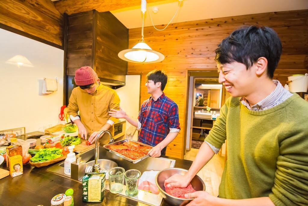 A group of people in a kitchen preparing food.
