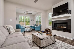 A living room with a sofa, chairs, a coffee table, a fireplace, and a TV. - Bayside Resort * 1 Small Dog Allowed: Luxury 5BR B (Selbyville)