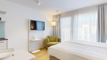 Studio, Courtyard View | Living area | Flat-screen TV
