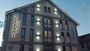 A hotel named "STEFANI" with a modern design, multiple windows, and a restaurant sign. - Hotel Stefani (Sibiu)
