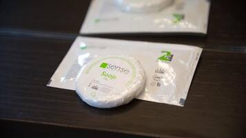 Two packages of soap on a dark wooden surface.