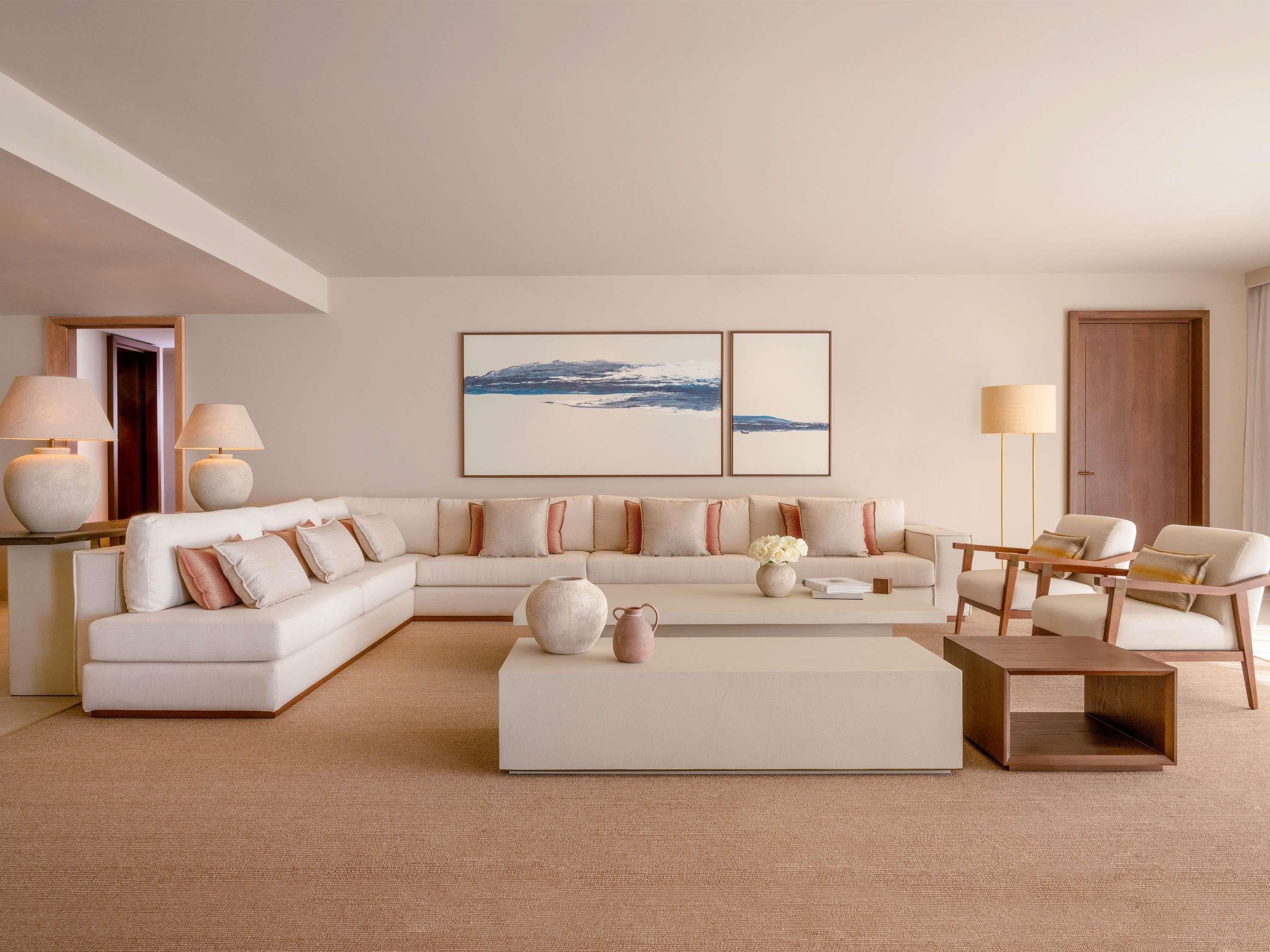 A modern living room with a sectional sofa, a coffee table, and two floor lamps.